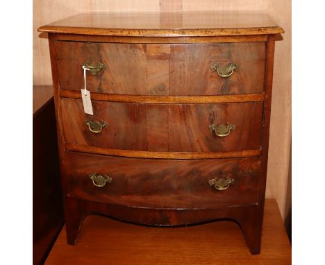 A small mahogany three drawer bow front chest W.66cm