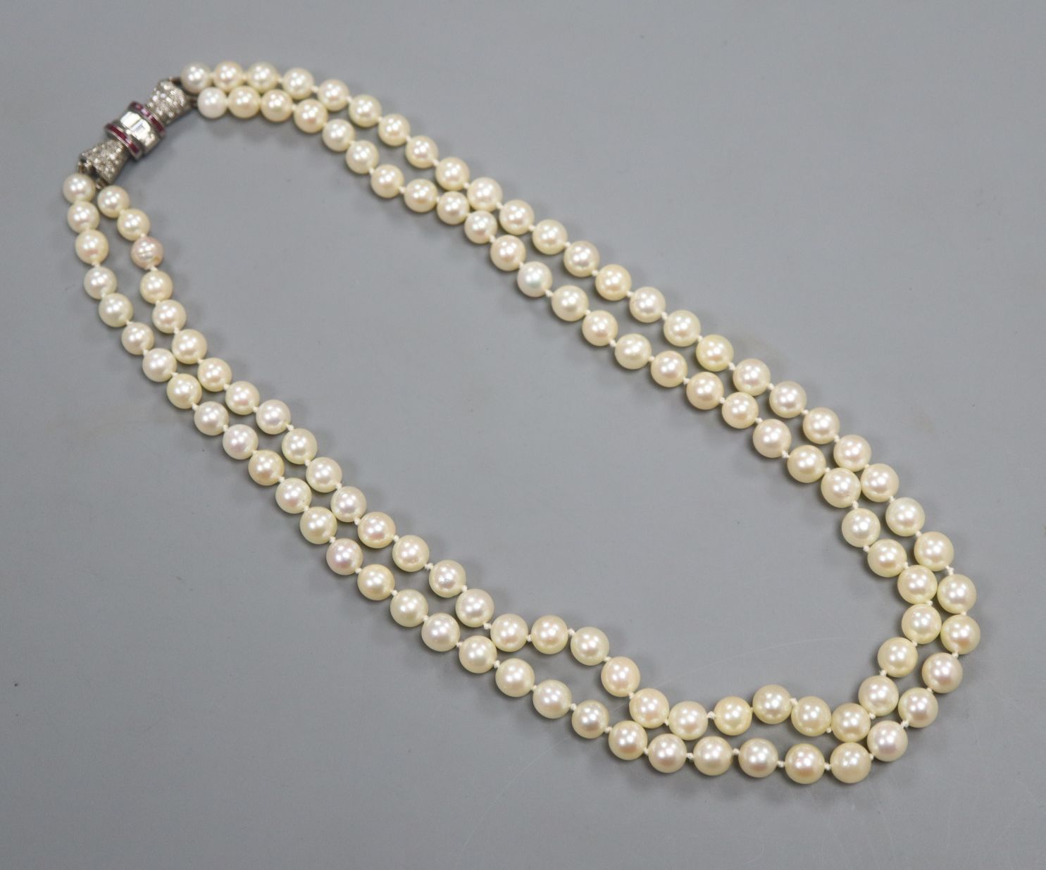 A doublerow cultured pearl choker necklace with diamond and rubyset
