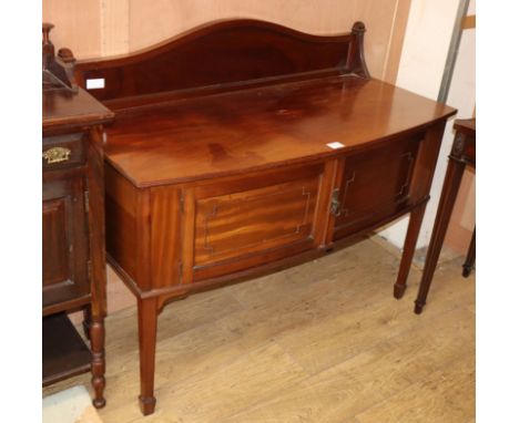 A 1920's mahogany bow front wash stand W.116cm