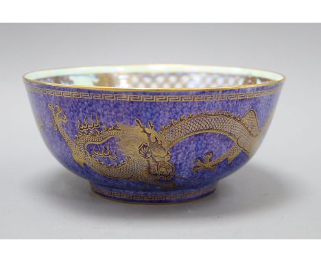 A Wedgwood lustre dragon bowl designed by Daisy Makeig-Jones, the mottled blue exterior decorated with dragons chasing a flam