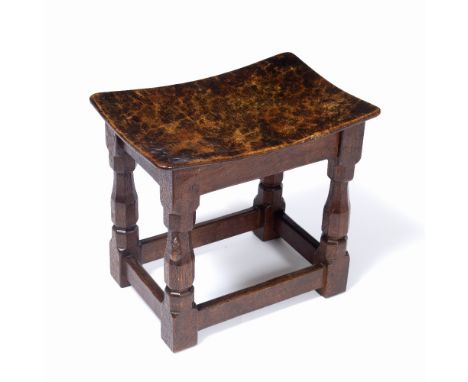 Robert Thompson of Kilburn (1876-1955)  Early Mouseman stool, circa 1930 burr oak, the adzed rectangular concave seat on octa