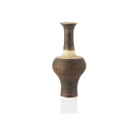 Lucie Rie (1902-1995) Bottle vase manganese glaze with sgraffito decoration 23cm high, 10.5cm across. Provenance: Collection 