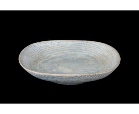 Lucie Rie (1902-1995) Dish, circa 1950 white glaze with blue lines impressed potter's seal 24.4cm across. Literature: Lucie R
