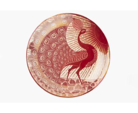 William De Morgan (1839-1917) Charger, circa 1880s decorated in ruby lustre depicting a peacock parading under the sun, the r
