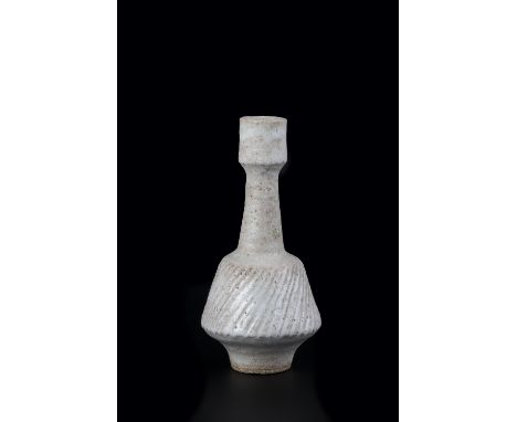Lucie Rie (1902-1995) Bottle vase stoneware, white pitted glaze with fluted body impressed potter's seal 22cm high. Provenanc