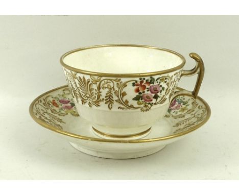 An over sized tea cup and saucer, hand painted with flowers and gilded highlights, and a part tea service, decorated with gre