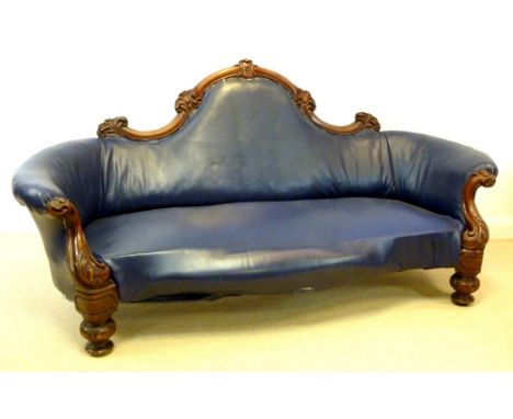 A Victorian mahogany settee, circa 1880, with shaped back, carved and moulded rail with foliate decoration, scroll over arms,