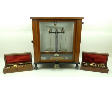 A Sikes' Hydrometer, cased, 22 by 9 by 7cm, another similar, 20 by 10 by 5cm, and a set of laboratory scales in a mahogany an