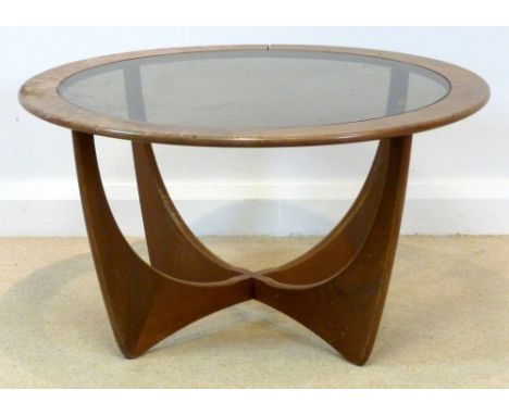 A Ercol coffee table, circa 1970's with circular glass inset and shaped base, 84 by 46cm high.