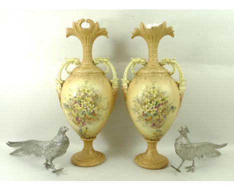 A pair of Victorian vases in the style of Royal Worcester blush ivory, decorated with flowers and foliage, with two handles, 