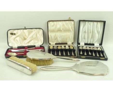 A three piece silver dressing table set comprising hand brush, clothes brush, and hand mirror, Birmingham 1933, a boxed Viner