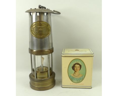 A miners lamp, by E. Thomas & Williams Ltd, Aberdare, Wales, 26cm, and a 1953 Coronation tea tin, 10 by 7 by 12cm. (2)