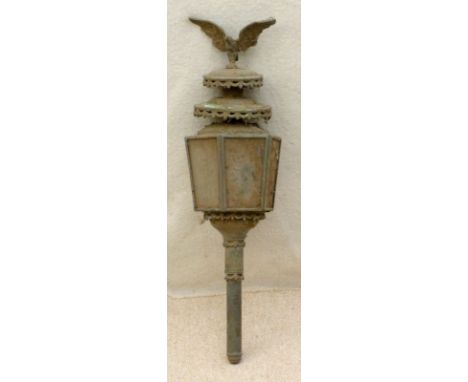 A Victorian coach oil lamp, the cast hexagonal body with glass panels and pierced trim, with an eagle crest finial, 18 by 73c