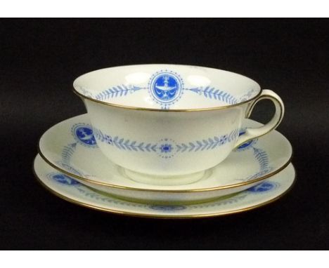 A Wedgwood part tea service, gilded blue transfer on a white ground, comprising milk jug, two cake plates, and twelve tea cup