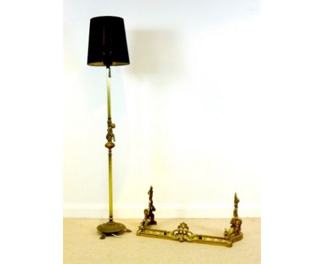 A brass standard lamp, circa 1930 with Corinthian column, and cherub central figure, on a circular base with lion's paw feet,