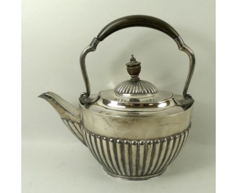 A Japanese silver teapot, early 20th century, with reeded body and domed lid, and possibly later ebonised scroll handle and f