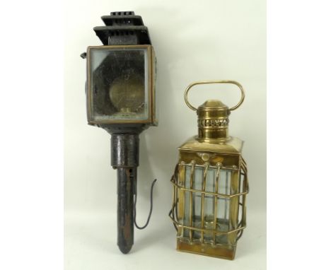 A carriage lamp, circa 1830, painted black, 44cm, and a paraffin lamp with cage chimney and brass carrying handle, 31cm. (2)