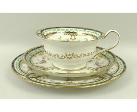 A late 19th century Wedgwood porcelain part tea service, decorated with a dark blue band, leaf frieze and floral sprays with 