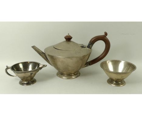 An Art Deco silver three piece tea service, comprising tea pot, milk jug and sugar bowl, of conical form on stepped circular 