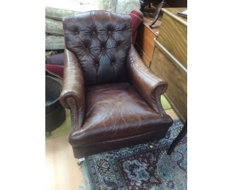 Two contemporary brown leather armchairs,one button backed, together with two brown leather pouffes. (4)