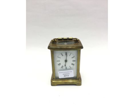 A 19th Century brass cased carriage clock, with a white enamelled, dial with key