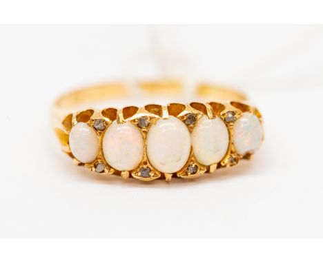 A Victorian opal and diamond 18ct gold boat head ring, set with five graduated oval opals, diamond accents, size O, total gro