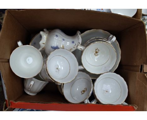 A two part tea services 8 cups and 7 saucers, sugar bowl and jug, with blue floral pattern with a bone china 6 cup and saucer