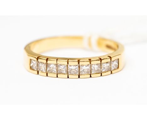A diamond eternity ring, set with nine princess cut diamonds, total diamond weight approx 0.54ct, bar/channel set in 18ct gol