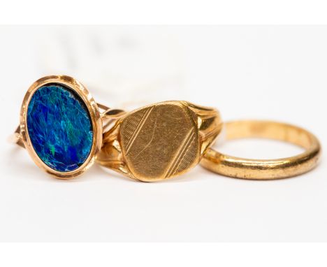 Three 9ct gold rings, to include an opal doublet displaying blue and green play of colour, crazing to stone, size M1/2 set in