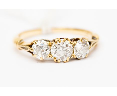A diamond three stone ring claw set in 18ct gold, the old cut  diamonds weighing a total of approx 1.10 carat, size O1/2, tot