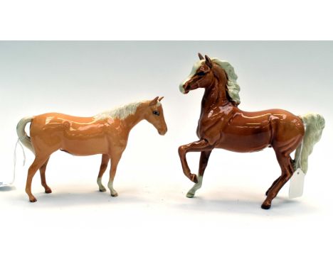 A Beswick palomino prancing horse, plus a further lighter bay horse