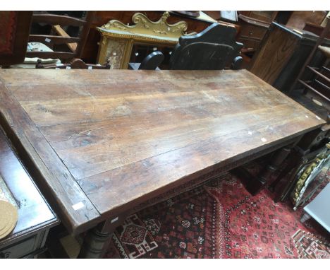 Large carved oak dining table with substantial turned legs together with four ladder back chairs.