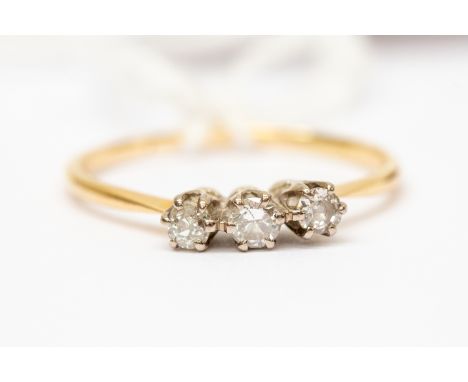 An 18ct yellow gold and platinum three stone diamond ring, total diamond weight approx 0.25ct, size P1/2, total gross weight 