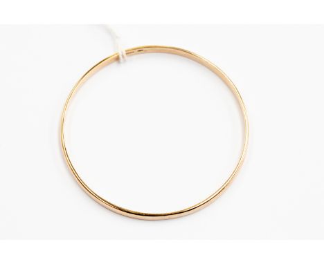 A 9ct gold plain polished slave bangle, internal diameter approx 70mm, weight approx 16.1 grams 