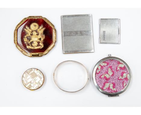 A silver bangle, Birmingham 1973, a German powder compact mirror, pill box, chrome stamp book and chrome notebook (6)