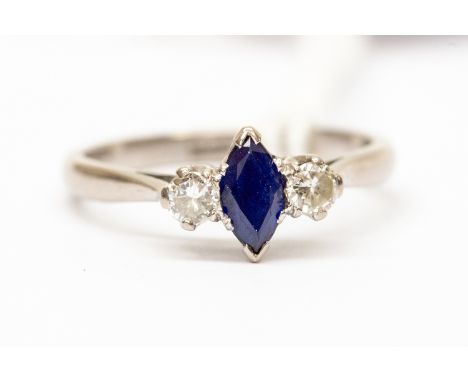 A sapphire and diamond three stone dress ring, the marquise cut sapphire approx 0.20ct, with two brilliant cut claw set diamo