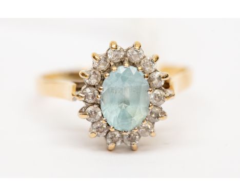 A cluster set dress ring,  set with a blue oval topaz with paste set border, 9ct gold, size R, total gross weight approx 3.3g