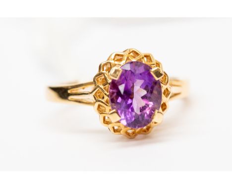 An amethyst and 14ct gold dress ring, set with an oval amethyst with fancy mount, size P, total gross weight approx 4gms