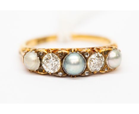 An Edwardian pearl and diamond ring, claw set in 18ct gold, alternately three split pearls and two old cut diamonds, each of 