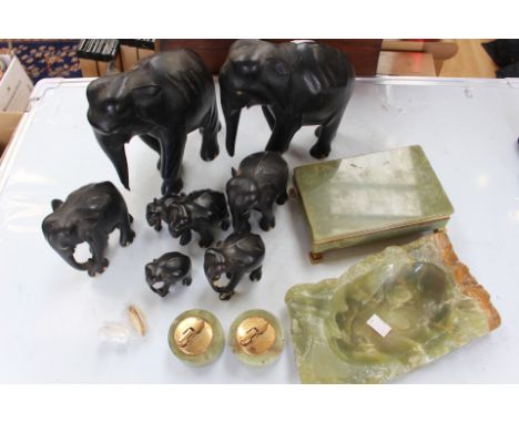 Collection of carved ebony elephants along with onyx cigarette box, ashtray, two lighters (1 box)