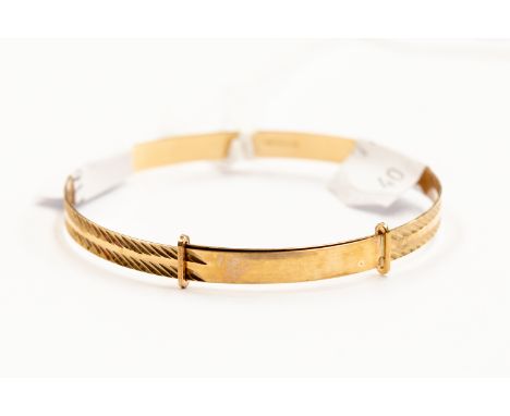 A 9ct gold child's expander bangle, diamond cut engraved top, weight approx 3.4gms