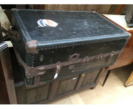An early 20th Century travelling trunk, complete with a fitted interior, with various drawers and compartments, one section w