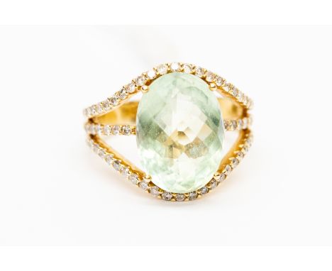 A 14k dress ring, set with an oval faceted blue/green quartz with diamond set shoulders, the check board quartz measuring app