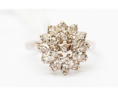 A platinum and  diamond cluster ring, tired cluster set in unmarked white metal probably 9ct gold, size K, total gross weight