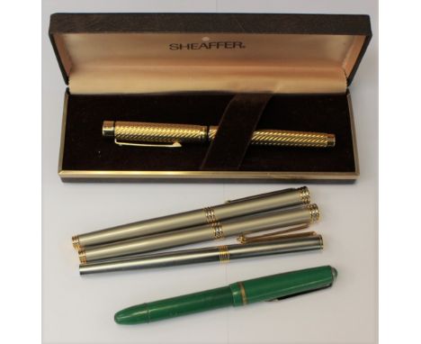 A gold plated Sheaffer fountain pen, 14 k nib; a German Pluma fountain pen with a plated nub, pen Quest and two other fountai