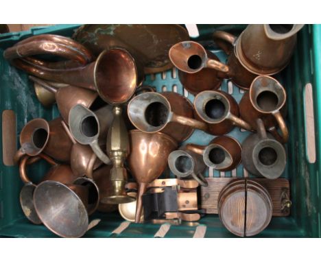 Collection of brass and copper wares, measuring jugs, funnels and bugle