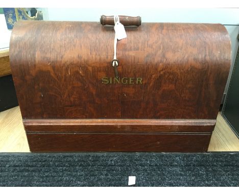 A Singer sewing machine, complete and unused with original manual and cardboard light holder