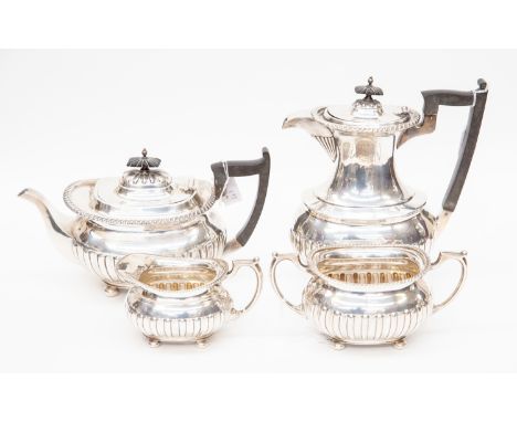 An Edwardian four piece sterling silver tea and coffee service, by Walker &amp; Hall, comprising teapot, coffee pot, milk jug