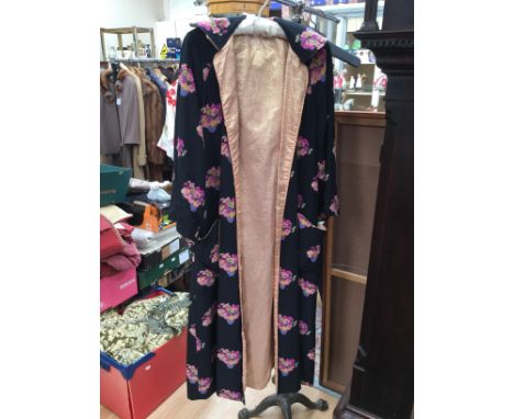 A CHLOE gown/robe, 1970's, which has an Oriental floral design, the fabric is black satin with a shade of pink floral posies,