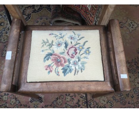 A piano stool with a woolwork panel in lid.